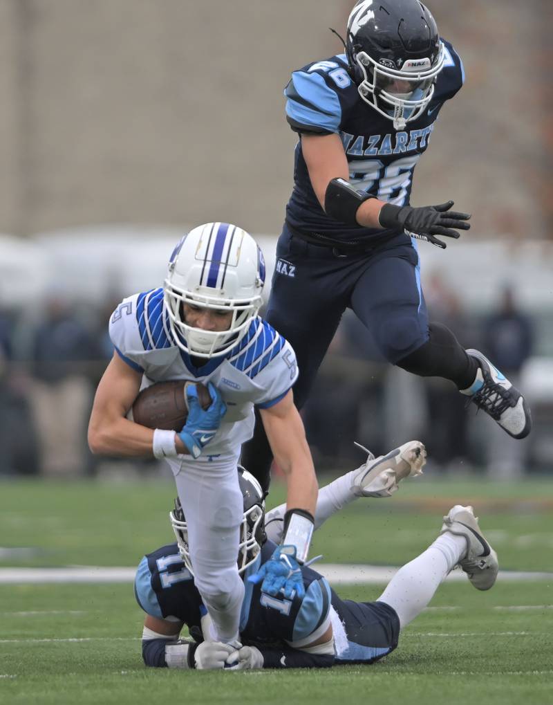 St. Francis’ Zach Washington catches a first down against Nazareth with 20 seconds left in the first half in the IHSA Class 5A state semifinal football game in La Grange on Saturday, Nov. 23, 2024.
