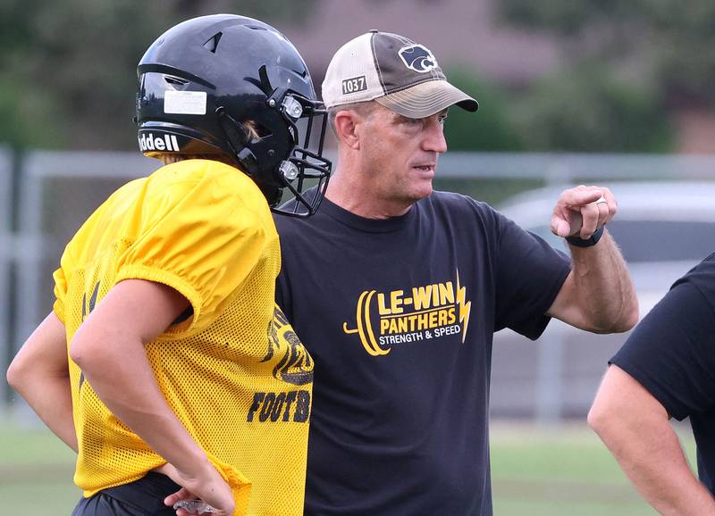 Lena-Winslow head coach Ric Arand talks to a player Thursday, July 24, 2025, during a joint practice with Byron, Lena-Winslow and Sycamore at Sycamore High School.