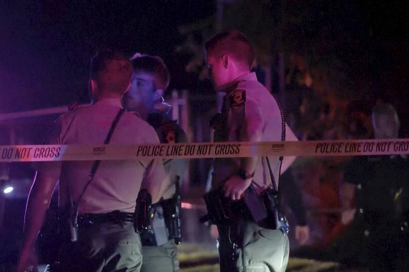 Law enforcement agents respond to the scene of a shooting late Wednesday, Aug. 30, 2023 in Peoria, Ill.  Several people were shot and two of them were in critical condition, police said. (WEEK/WHOI via AP)