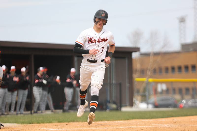 Lincoln-Way West’s Kaleb Wilkey scores on a wild pitch against Minooka. Friday, April 15, 2022, in New Lenox.