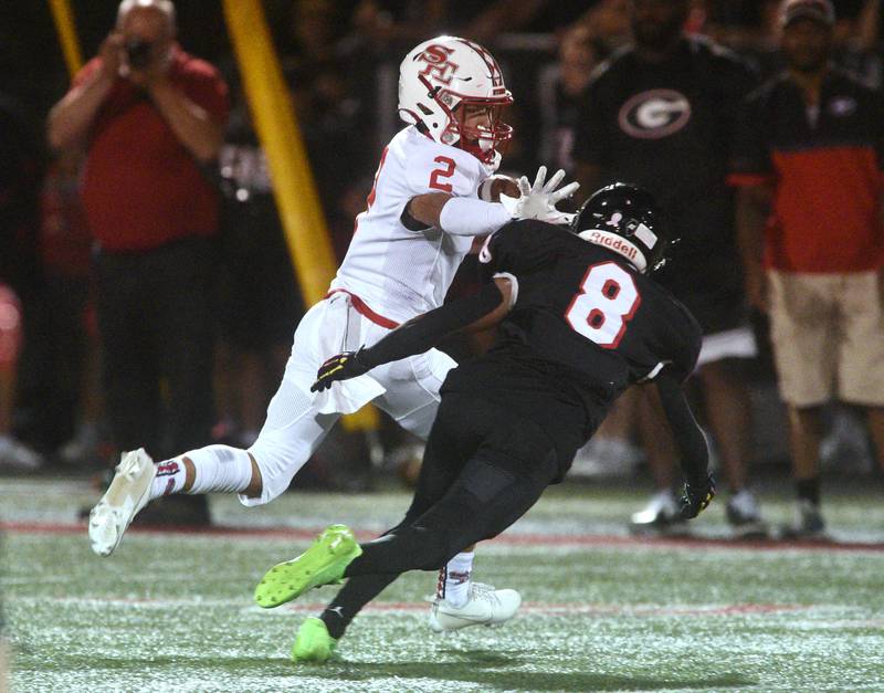 South Elgin's Stewart Williams Jr (2) runs the ball on a fake punt play during Friday’s football game against Glenbard East in Lombard.