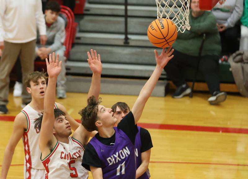 Dixon's Brody Nicklaus lets go of a shot under the hoop as L-P's Erick Sotelo guards him on Tuesday, Jan. 20, 2026 in Sellett Gymnasium at L-P High School.