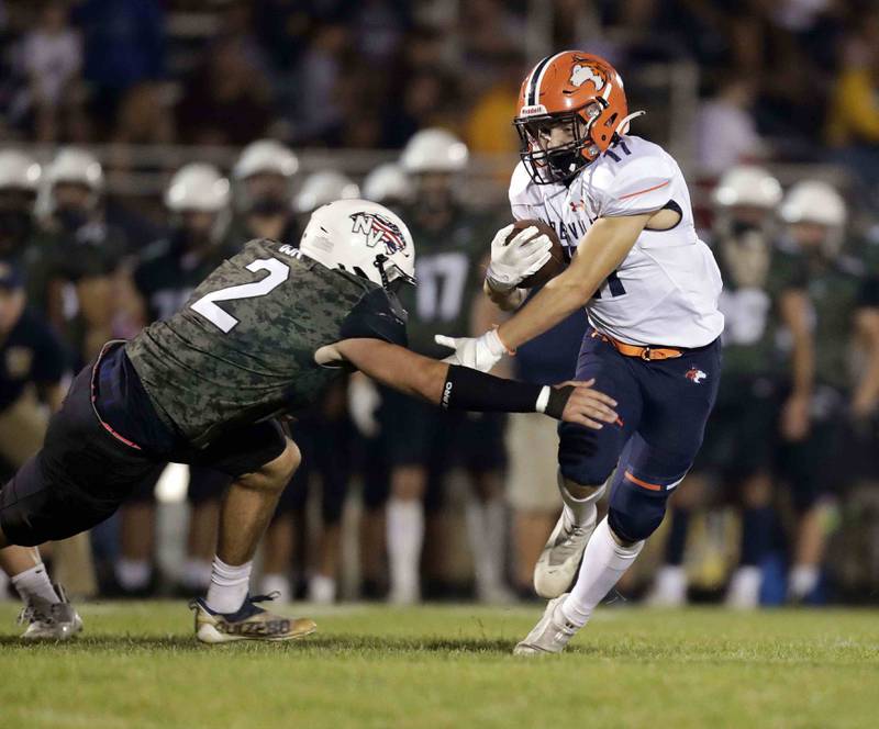 Neuqua Valley's Cole Dutkovich (2) tries to wrap up Naperville North's Danny Eloe (17) Friday September 16, 2022 at Barbara J. Barrows Stadium in Naperville.