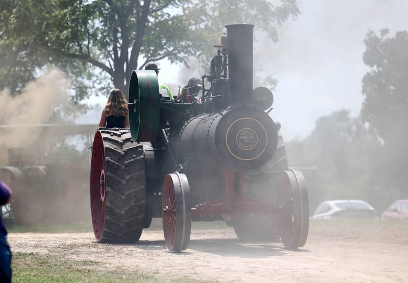 A steam powered tractor emerges from the clouds of steam Thursday, Aug. 7, 2025, at the 68th annual Sycamore Steam Show and Threshing Bee at Taylor Marshall Farm on Lukens Road in Sycamore.