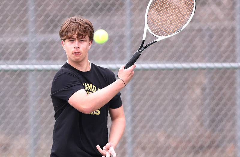 Sycamore’s Jonathan Locascio follows through on a forehand during his number one doubles match along with partner Liam Kerbel against Dixon Thursday, March 30, 2023, at Sycamore High School. This is the inaugural season for the Sycamore boys tennis team.