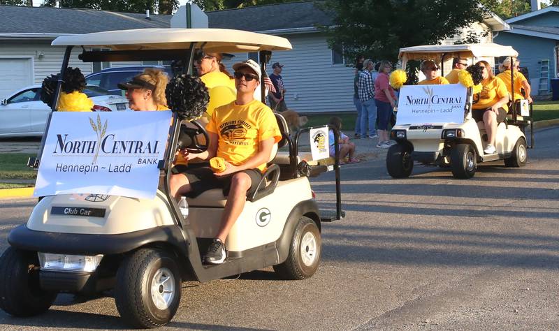 The staff of North Central Bank in Hennepin, ride on a golf cart during the inaugural Homecoming parade on Wednesday, Sept. 17, 2025 down Elm Street in Granville.
