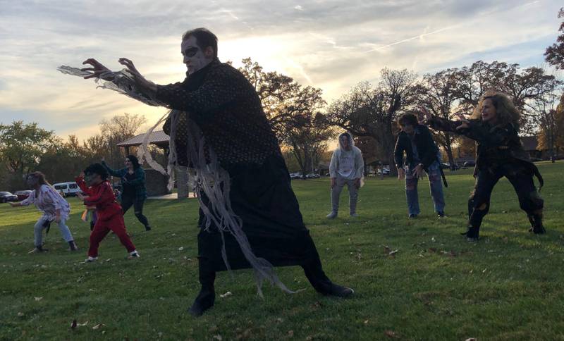 Performers in TSC studios' "Thriller" flash mob perform the Thriller dance Saturday, Oct. 29, 2022 in Centennial Park in Peru.