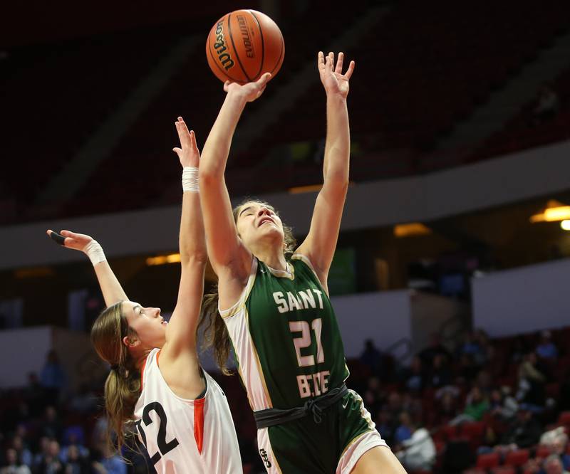 St. Bede's Lili Bosnich lets go of the ball under the hoop as Altamont's Kylie Osteen defends during the Class 1A third-place game on Thursday, Feb. 29, 2024 at CEFCU Arena in Normal.
