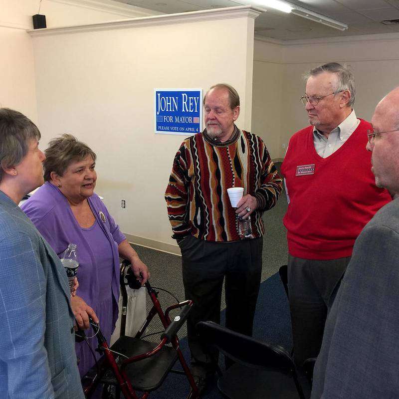 Bessie Chronopoulos (second from left), talks with DeKalb mayoral candidates (from left) Misty Haji-Sheikh, Michael Embrey, Jerry Smith, and incumbent John Rey during a forum held at the former Finest Furniture building Feb. 26 in DeKalb.