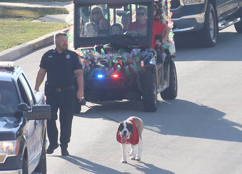 Peru Police officer Brian Zebron walks Haven the new therapy dog in the L-P Homecoming parade on Thursday, Sept. 26, 2024 near the corner of 7th Street and Orleans Street in Peru.