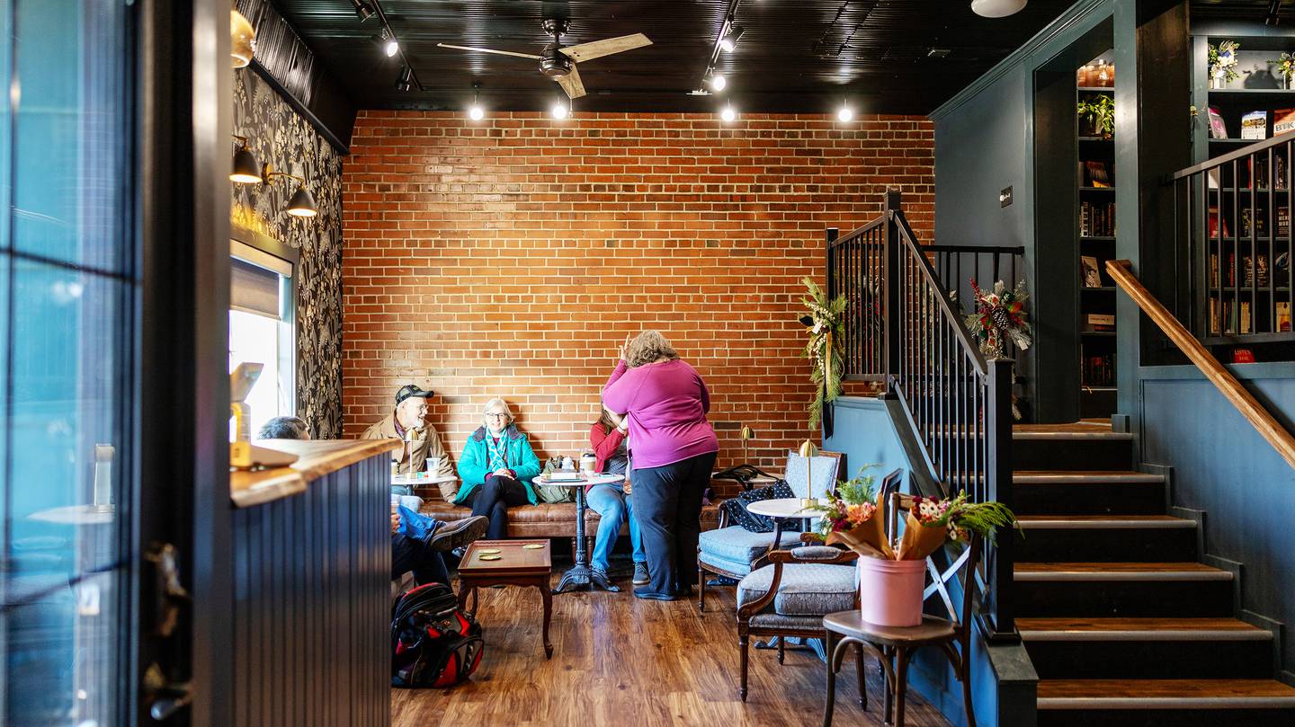 Customers gather in the downstairs seating area at The Novel Bloom on Saturday, Jan. 4th, 2025. The shop offers two levels of seating, bookshelves and goods for sale.