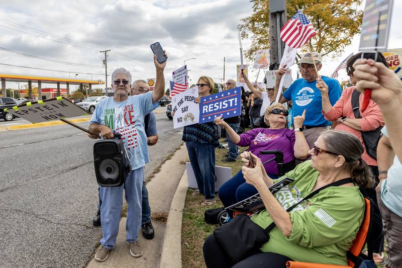 Miguel Duron plays music while walking through the crowd during the No Kings Protest in Joliet on Oct. 18, 2025.