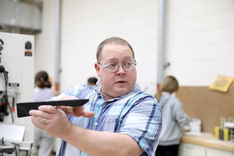 Kaneland Harter Middle School industrial arts teacher Michael Livorsi helps some of his seventh-graders build a CO2-powered drag cars out of wood. Livorsi was recently nominated for an Educator of the Year award from the Kane County Regional Office of Education.