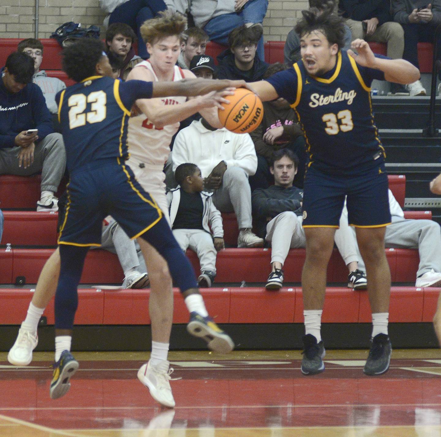 Ottawa’s Owen Sanders battles Sterling’s Xavian Phillips and Maddux Osborn for a rebound in the second quarter Friday during the Dean Riley Shootin’ The Rock Thanksgiving Tournament