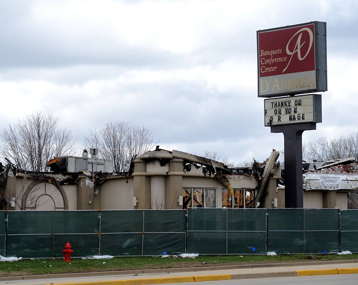 The fenced-off remains of the D’Andrea Banquets and Conference Center, at 4419 Route 14 in Crystal Lake, are photographed Tuesday, April 19, 2022. A fire Saturday left parts of the roof collapsed and the building a total loss, fire officials said.