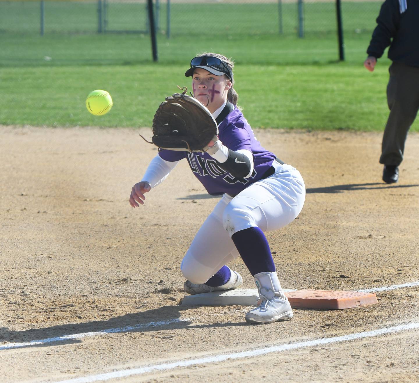 Dixon's Anna Kate Phillips watches the ball in to her mitt during an out at first base against Oregon on Tuesday.