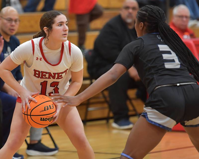 Benet’s Macy Menendez looks for an open teammate as Oswego East’s Avaya Kittling-Turner (3) defends during the Class 4A Benet Regional final on February 19, 2026 at Benet Academy in Lisle.