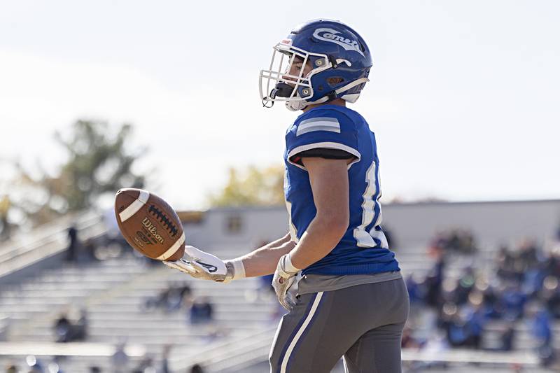 Newman’s Brady Grennan hands the ball back after a touchdown against ROWVA Saturday, Oct. 28, 2023 in the Class 1A playoffs in Sterling.