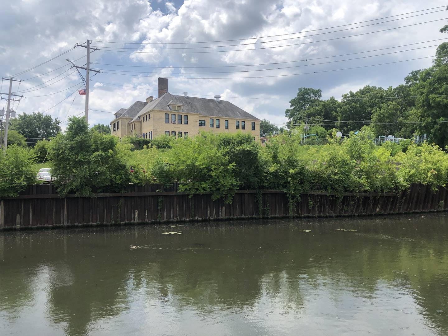 Boone Creek and Landmark Elementary School as seen from the Green Street parking lot on Thursday, June 13, 2024. The area behind the school is set for Phase 5 of McHenry's Riverwalk, and could be redeveloped along with adjacent parcels controlled by the city.