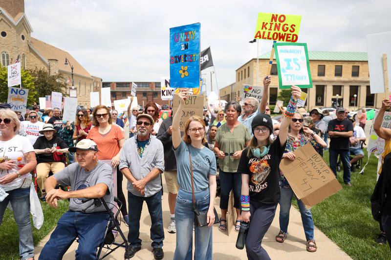 Protesters hold signs as approximately 500 people gathered at the Kankakee County Courthouse for a ‘No Kings’ rally in Kankakee on Saturday, June 14, 2025, to protest actions by President Donald Trump.