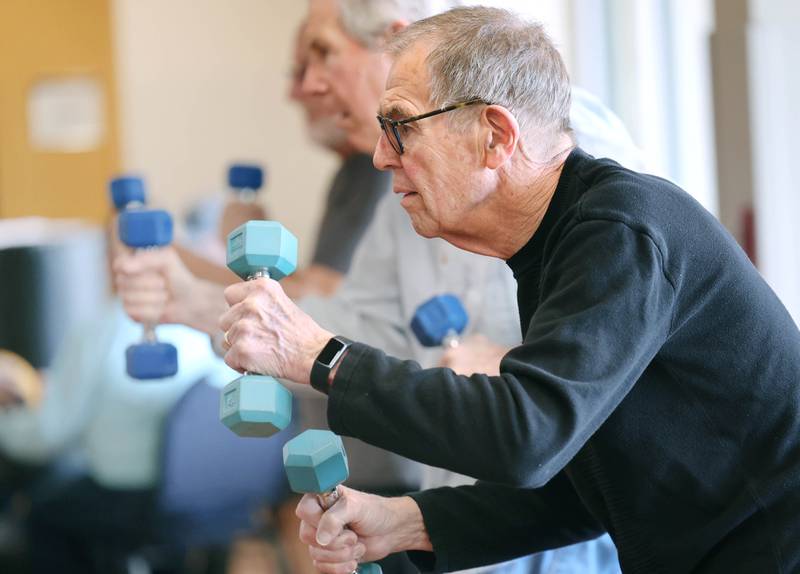 Peter Schram punches with weights Friday, April 28, 2023, during Rock Steady Boxing for Parkinson's Disease class at Northwestern Medicine Kishwaukee Health & Wellness Center in DeKalb. The class helps people with Parkinson’s Disease maintain their strength, agility and balance.