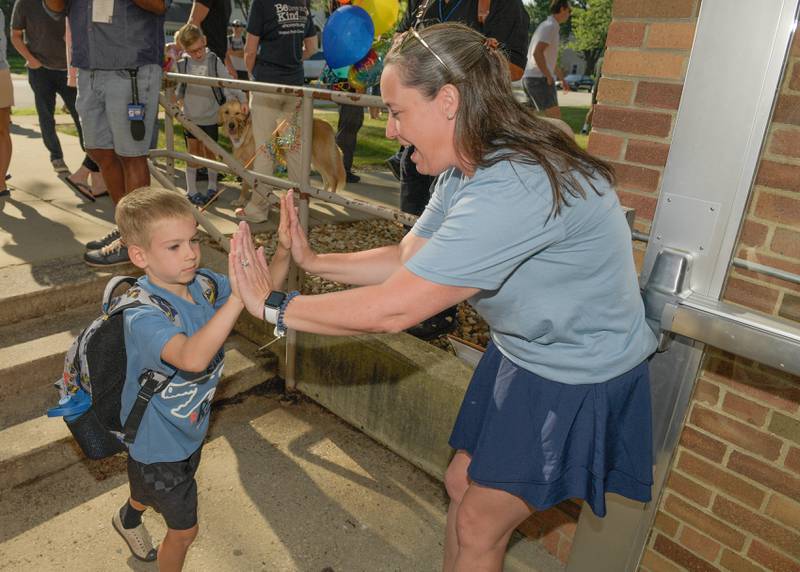 Davis Elementary STEM teacher Megan Oster welcomes students on the first day of class in St. Charles on Wednesday, Aug 13, 2025.