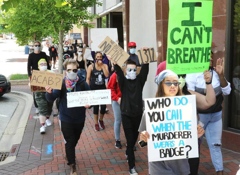 People chant as they march down Third Street in DeKalb during a Black Lives Matter protest Saturday. The protest drew hundreds of people who were angry about the recent deaths of Ahmaud Abrey, Breonna Taylor and George Floyd.
