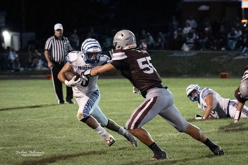 Princeton's Ace Christiansen tries to get past Rockridge's Landon Bull Friday night. The Tigers won 27-18.
