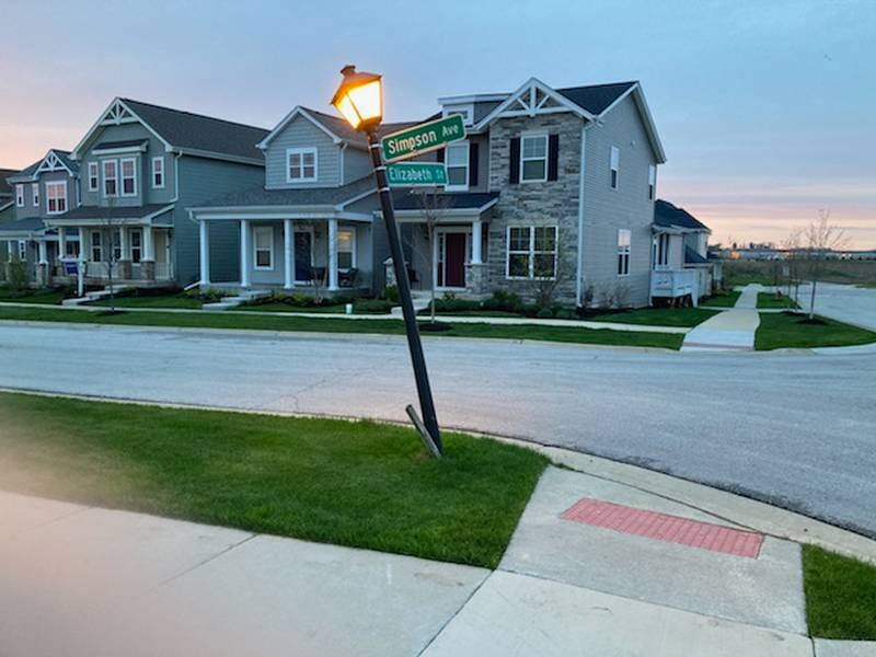 The light pole at Elizabeth Street and Simpson Avenue in Elburn has been on tilt since Nov. 14, 2021, when it was hit by a car. The village won’t fix it, saying it belongs to Elburn Station developer Shodeen. Shodeen says it belongs to the village. Residents just want it fixed.