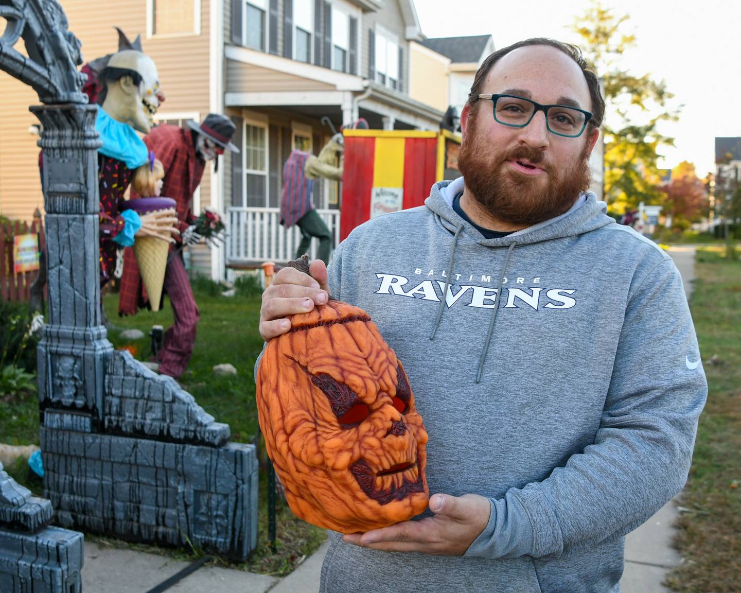 Phil Dienoff shows off the mask he wears where he plays a charter named Henry Gourd during the haunted yard that takes guest through his yard on Wednesday Oct. 16, 2024, in Oswego.