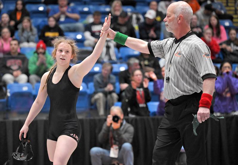 Glenbard East’s Nadiia Shymkiv is declared the winner over Saint Viator’s Charlotte Nold in the 105-pound class at the girls wrestling state finals tournament at Grossinger Arena in Bloomington on Saturday, Feb. 28, 2026.