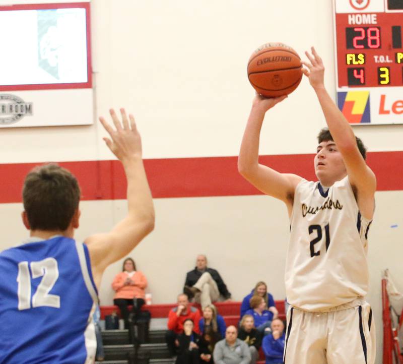 Marquette's Carson Zellers (right) shoots a jump shot over Princeton's Tyson Phillips (right) during the Colmone Classic tournament on Friday, Dec. 9, 2022 at Hall High School in Spring Valley.