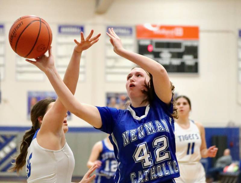 Newman's Lucy Oetting shoots against Princeton's Isa Ibarra Monday night at Prouty Gym.