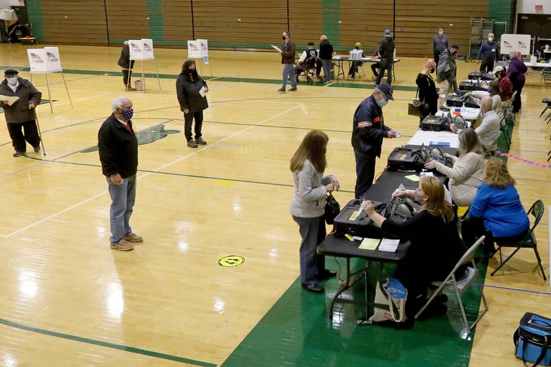Voters check in with election judges at Crystal Lake South High School on Tuesday, Nov. 3, 2020 in Crystal Lake.