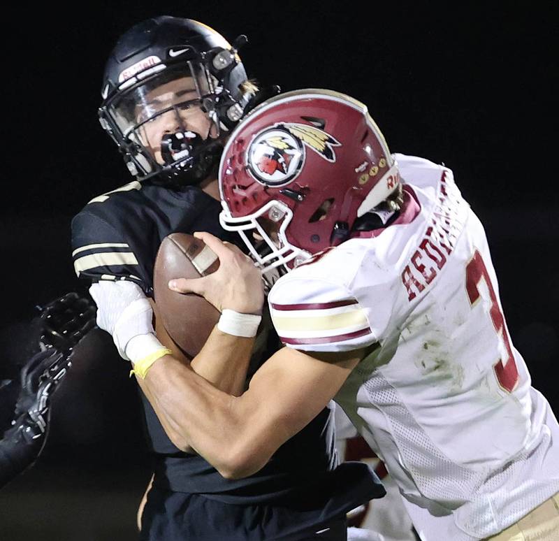 Morris' Sam Reddinger wraps up Sycamore's Elijah Meier during their game Friday, Oct. 21, 2022, at Sycamore High School.