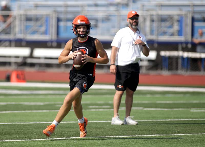 Wheaton Warrenville South quarterback Luca Carbonaro looks to pass the ball during a 7-on-7 football game against Hersey at St. Charles North on Thursday, June 22, 2023.