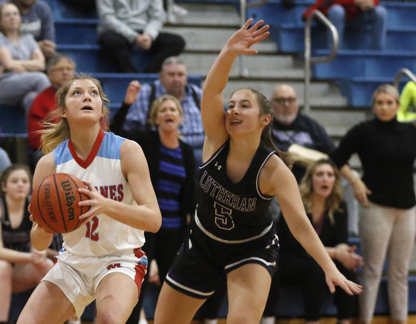 Marian Central's Madison Kenyon drives to the basket against Rockford Lutheran's Addie Richard during a non-conference girls basketball game Monday, Dec. 12, 2022, between Marian Central and Rockford Lutheran at Marian Central Catholic High School, in Woodstock.