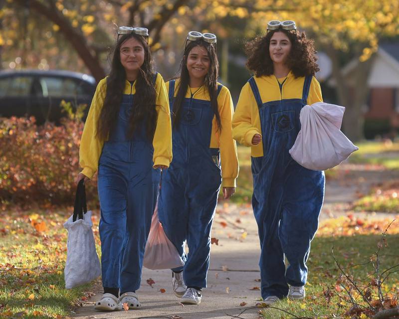 (From left) Jacqueline Davila, 13, Nataly Morales, 13, and Francesca Biundo, 13, enjoy trick-or-treating for Halloween on Thursday, Oct. 31, 2024, in DeKalb.