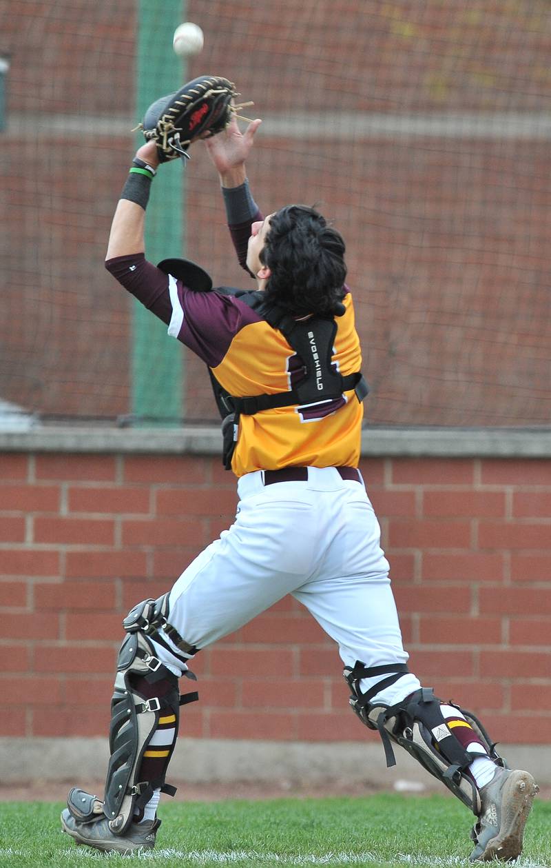 Montini catcher Vince McDowell catches a foul popup during a game against Benet on Apr. 28, 2022 at Benet Academy in Lisle.