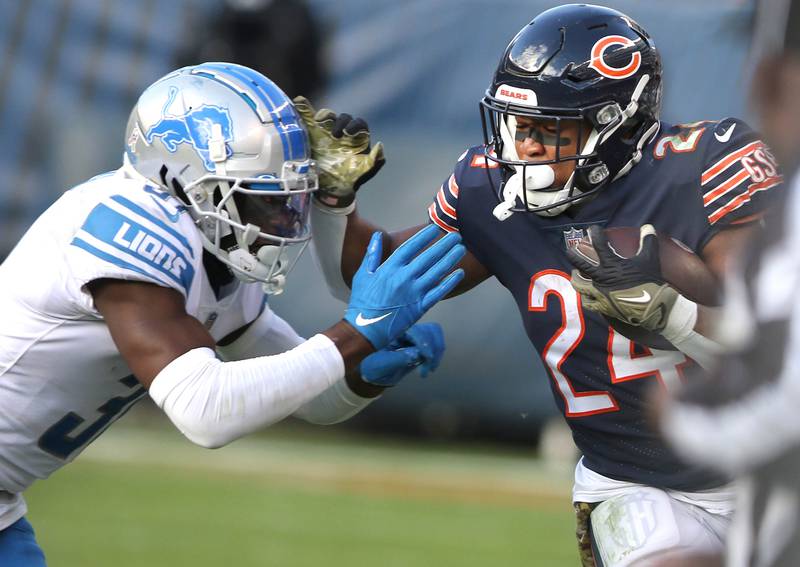 Chicago Bears running back Khalil Herbert tries to fend off Detroit Lions safety Kerby Joseph during their game Sunday, Nov. 13, 2022, at Soldier Field in Chicago.