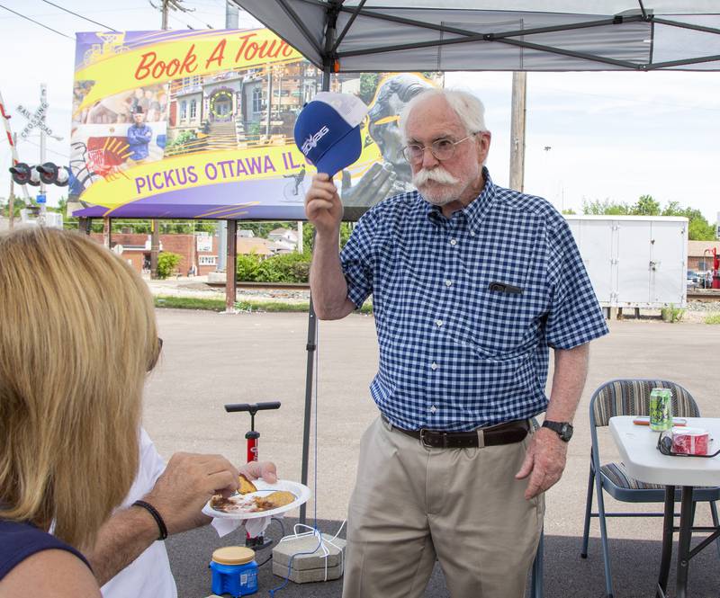 John Breslin talks with guests Saturday, July 2, 2022, at the Valley Immigrant Advocates grand opening and community open house in Ottawa.