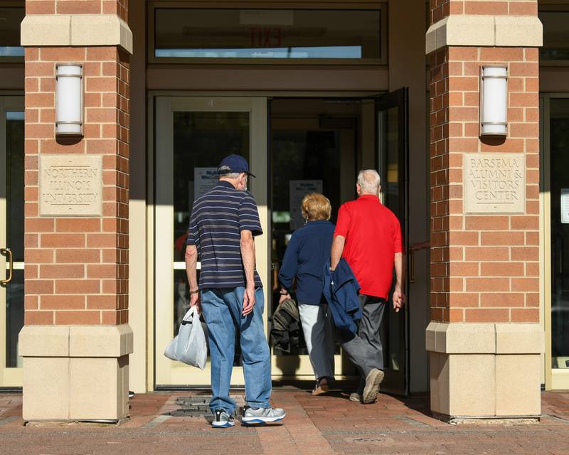 Community members walk into Northern Illinois University's Barsema Alumni and Visitors Center in DeKalb for the 20th anniversary of 50 Men Who Cook, an annual fundraising event benefiting CASA DeKalb County, on Saturday Aug. 10, 2024.
