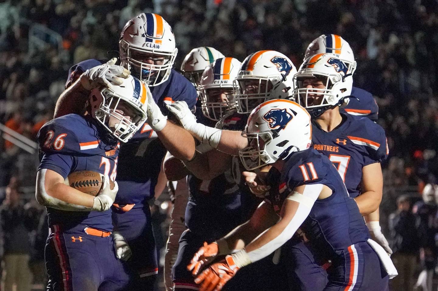 Oswego’s Dekker Zelensek (26) celebrates with his team after scoring a touchdown against Waubonsie Valley during a Class 8A first-round playoff game at Oswego High School on Friday, Nov. 1, 2024.
