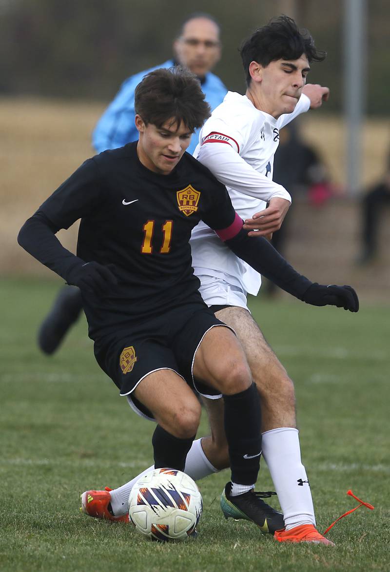 Richmond-Burton's Jack Meyer battles with F.W. Parker's F.W. Parker's Eric Maset Josa for control of the ball during an IHSA Class 1A Johnsburg Sectional semifinal match on Oct. 28, 2025, at Johnsburg High School.