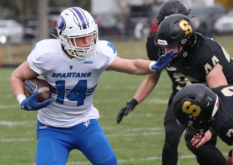 St. Francis' Liam Kolinski fends off Sycamore's Carter York Saturday, Nov. 16, 2024, during their Class 5A quarterfinal game at Sycamore High School.