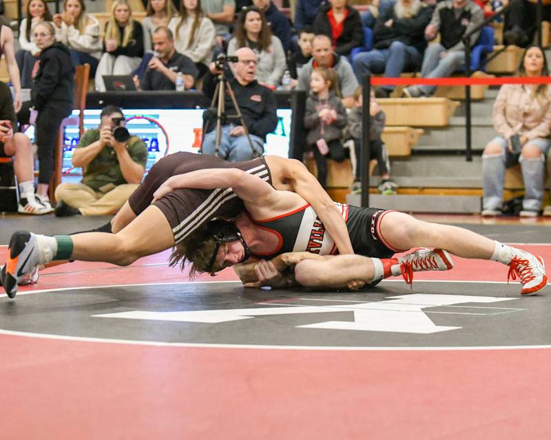 Nathan Craft of Yorkville, right, keeps a hold of Matthew Lair of Joliet Catholic Academy during the regional meet held on Tuesday Feb. 25, 2025, in the 126-weight class held at Yorkville High School.