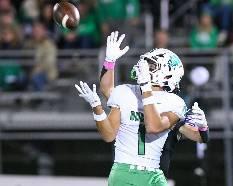 York's Simon Kodosky (1) catches a pass and runs in for a touchdown during the game on Friday Oct. 10, 2025, while being defended by Downers Grove North defender held at Downers Grove North High School.