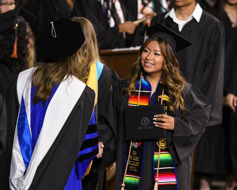 A DeKalb High School graduate is all smiles after accepting her diploma during the graduation ceremony on Saturday May 23, 2026, held at the Convocation Center in DeKalb.