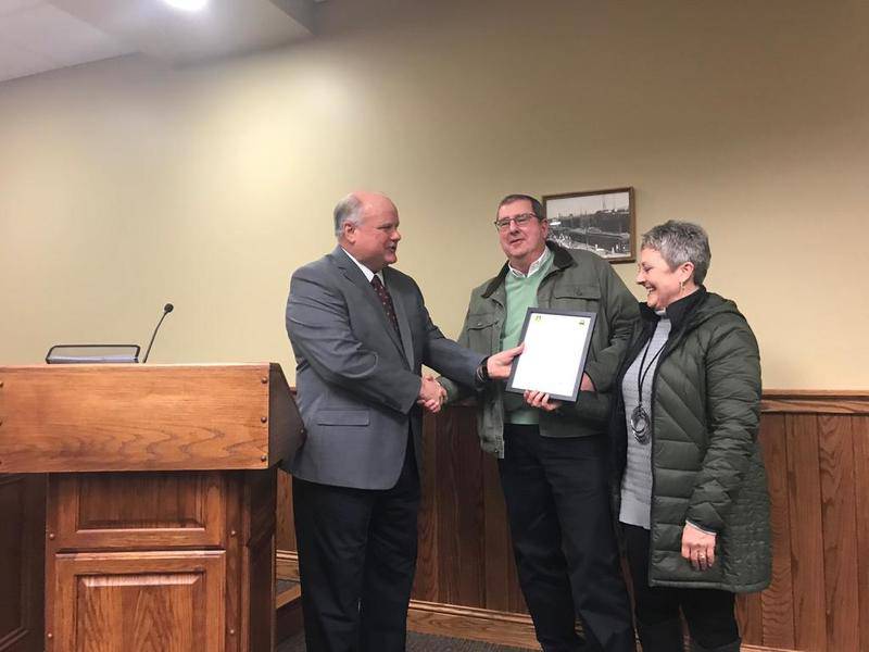 Mayor Scott Harl (left) presents longtime businessman Henry Hackman and wife Deb Hackman with a certificate naming him a "Peru Good Neighbor." Hackman, a longtime State Farm agent, retired at the end of January after 40 years.