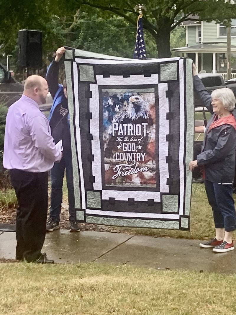 Mitch McCoy of Princeton, retired US Army veteran, receives the Quilt of Valor during Monday's 9-11 Remembrance Ceremony, at Soldiers and Sailors Park in Princeton.